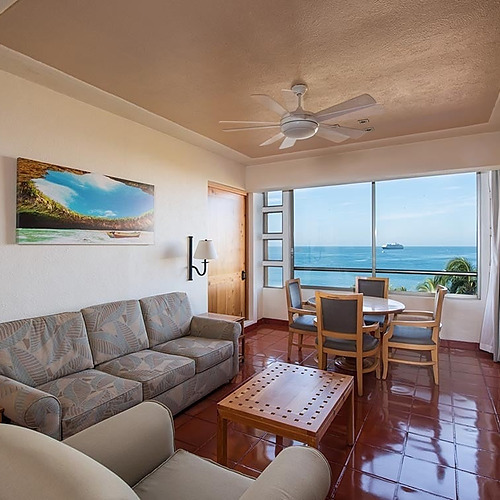 Travel Raintree Corpo ocean-view suite with living room, dining area, and balcony.