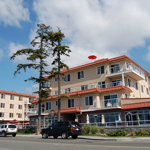 Travel Raintree Corpo oceanfront hotel with balconies and restaurant.