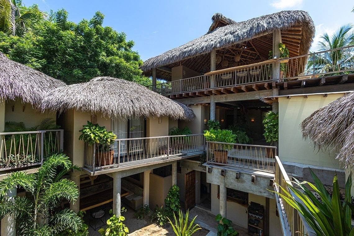 a building with thatched roofs and balconies