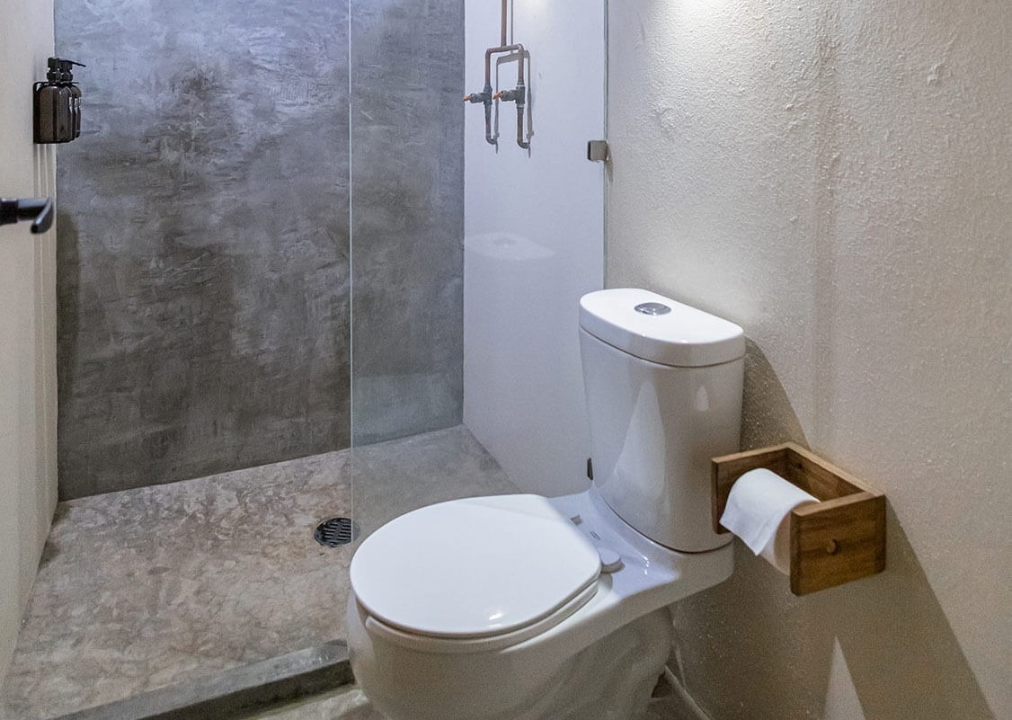 a toilet in a bathroom next to a shower