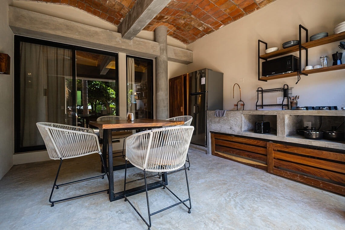 a kitchen with a table and chairs and a microwave