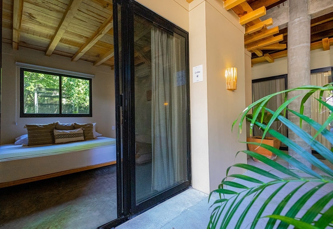 a bedroom with a sliding glass door leading to a balcony