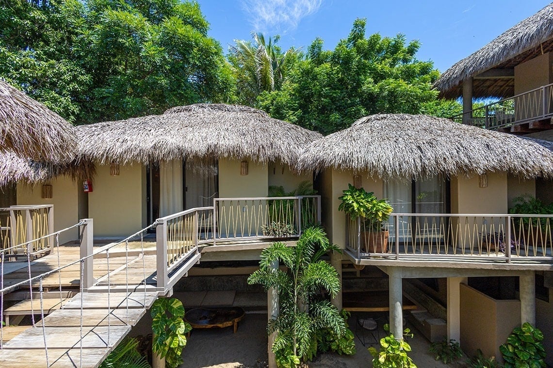 a thatched roofed building with stairs leading up to it