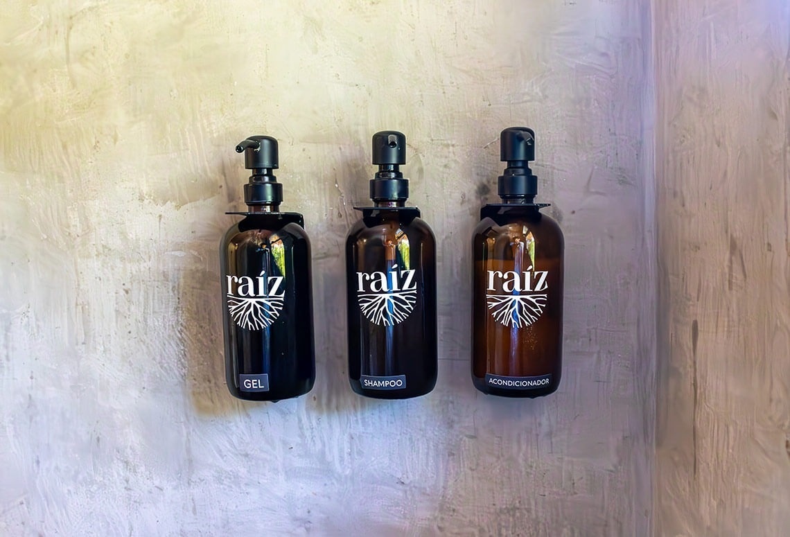 three bottles of raiz are hanging on a wall