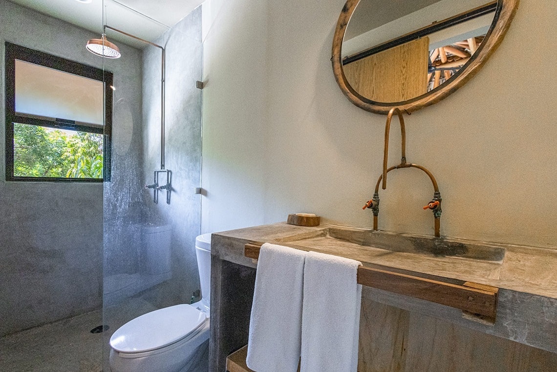 a bathroom with a toilet a sink and a mirror