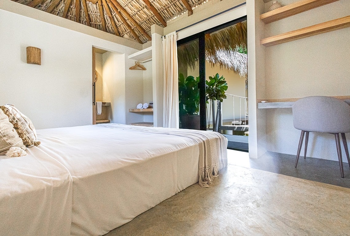 a bedroom with a sliding glass door leading to a balcony