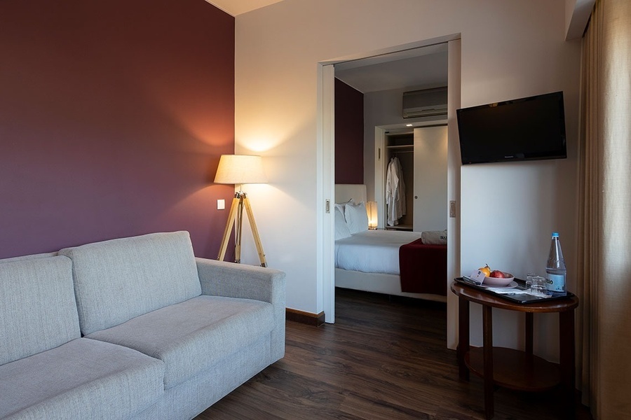 a hotel room with a couch and a television