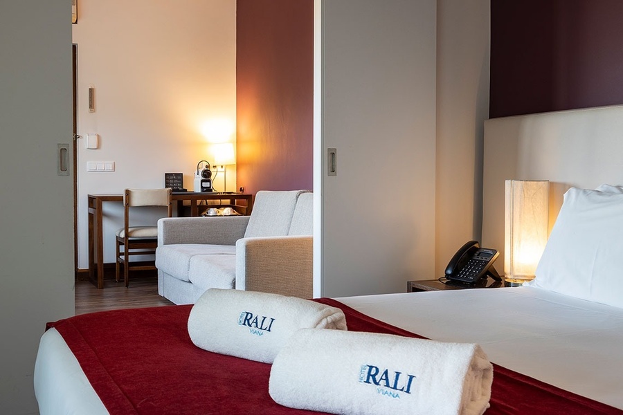 a hotel room with two towels that say ' rali ' on them