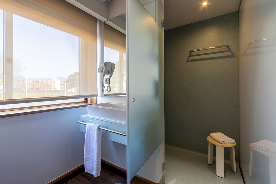 a bathroom with a sink and a glass door