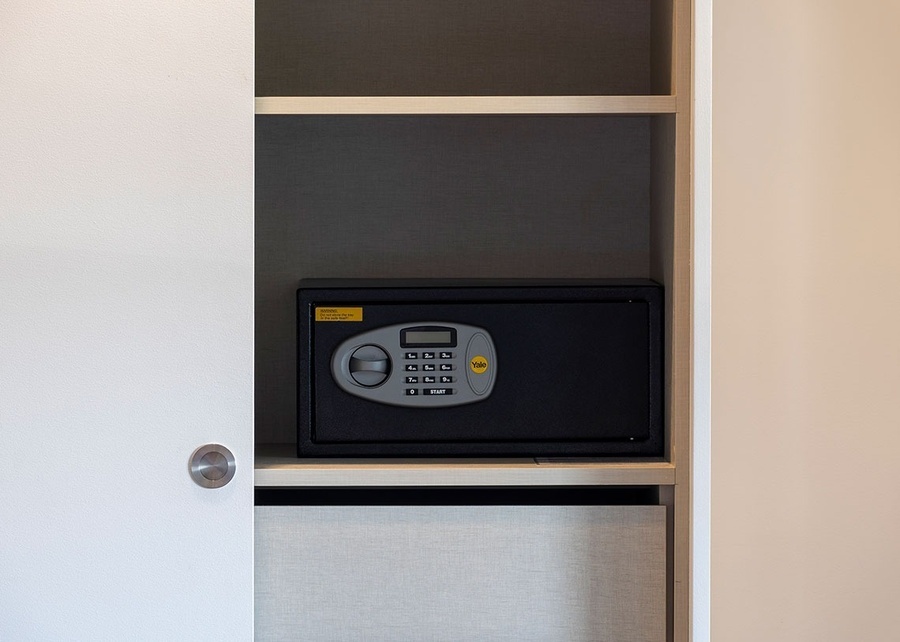 a yale safe sits on a shelf in a closet