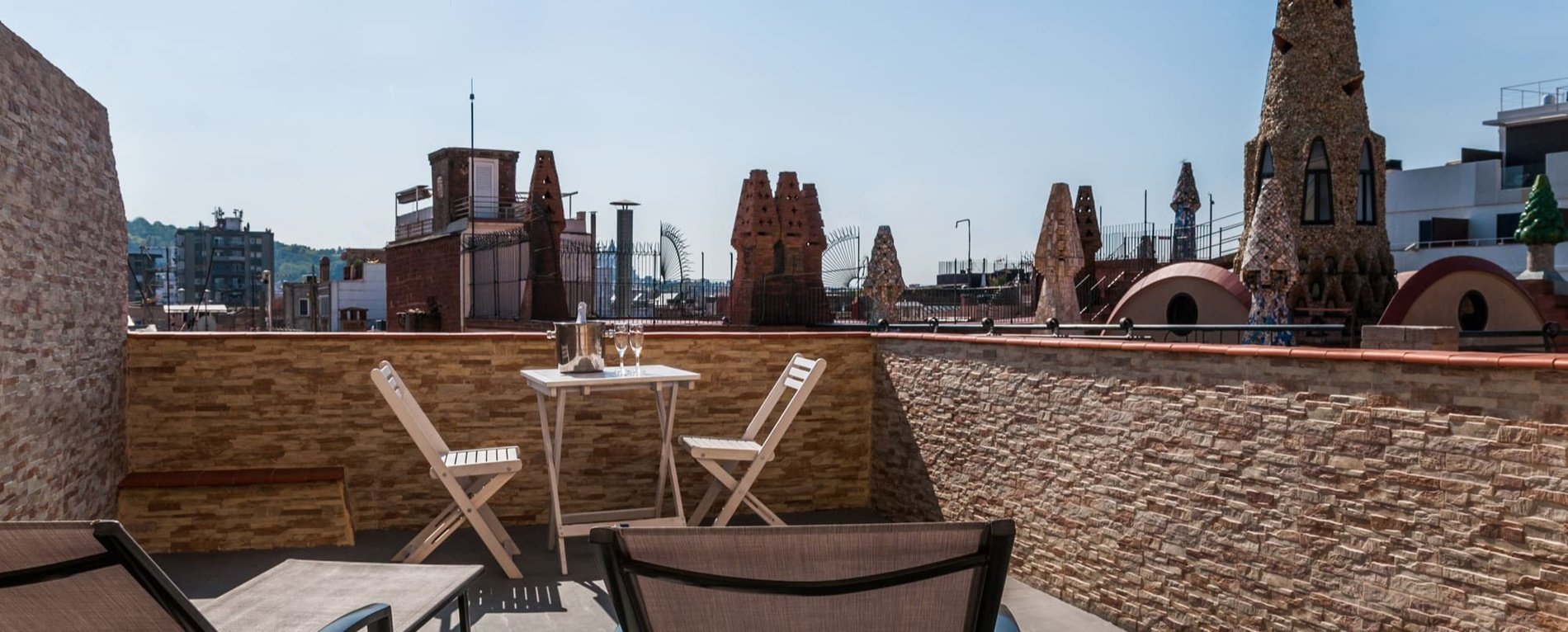 a balcony with a table and chairs and a view of the city