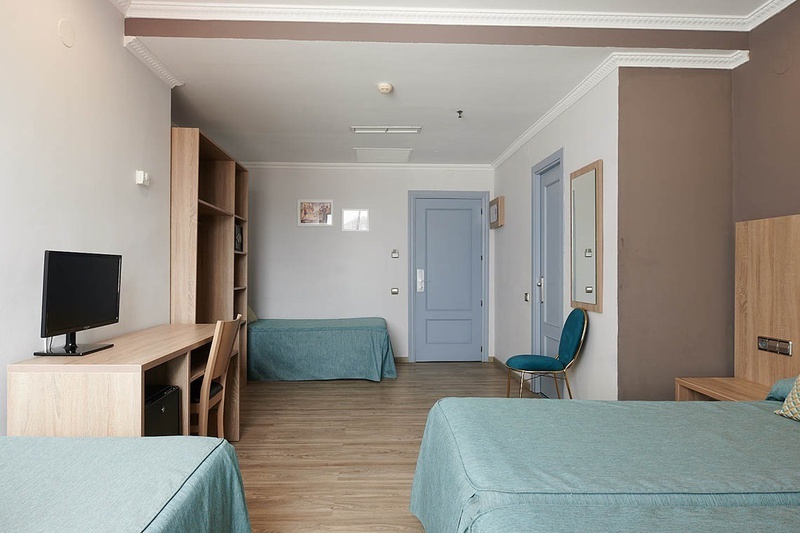 a hotel room with two beds and a desk