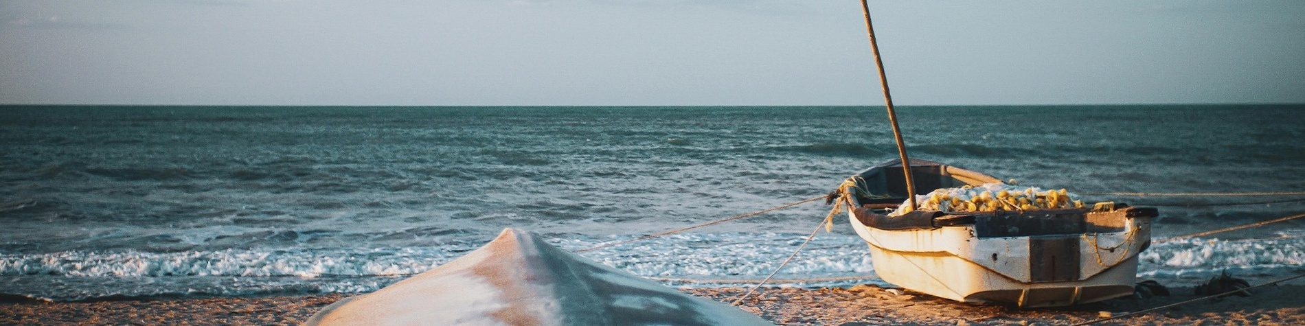 Barcos en la playa de Riohacha, perfectos para turismo. Descubre la Guajira con Ribai Hotels.