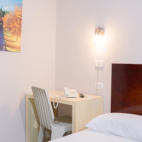 Habitación con escritorio y teléfono en Hotel Ribai Corporativa.
