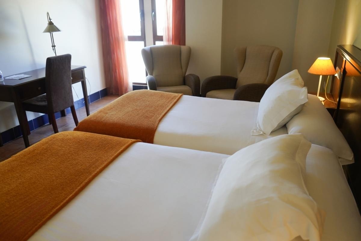 una habitación de hotel con dos camas y dos sillas