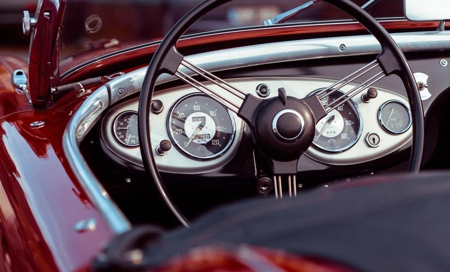 el tablero de un coche rojo con un velocímetro y un medidor de rpm