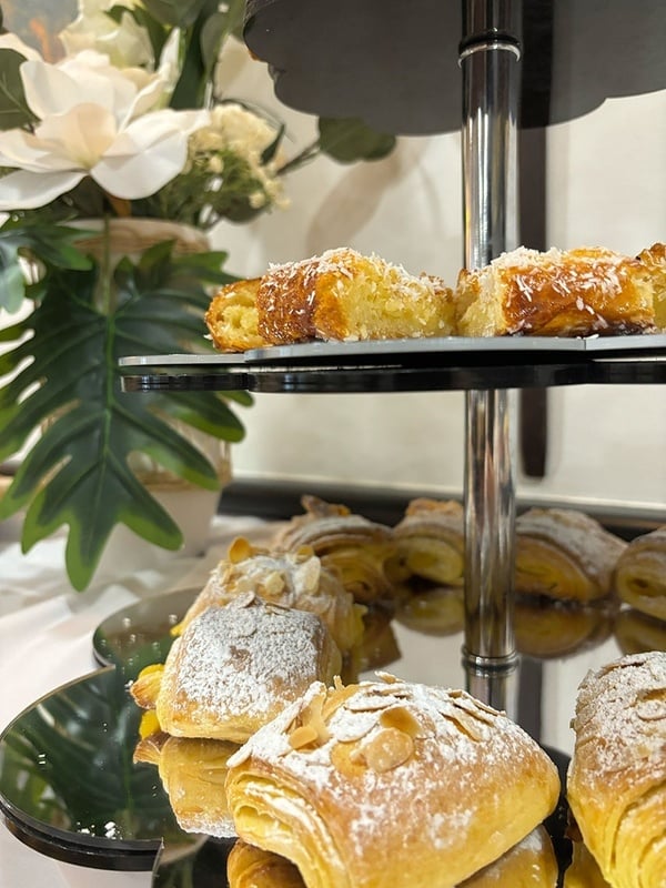 a display of pastries with powdered sugar on them