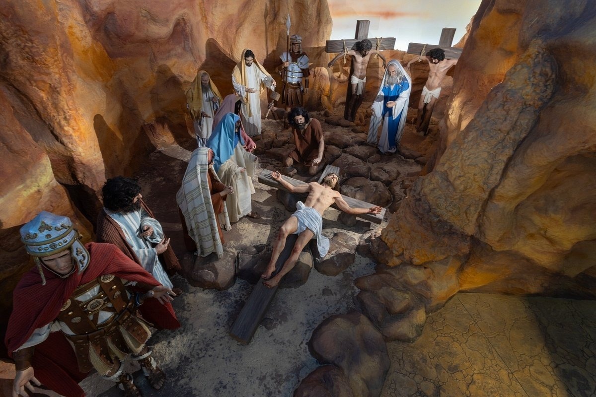 a group of people are standing around jesus on the cross .