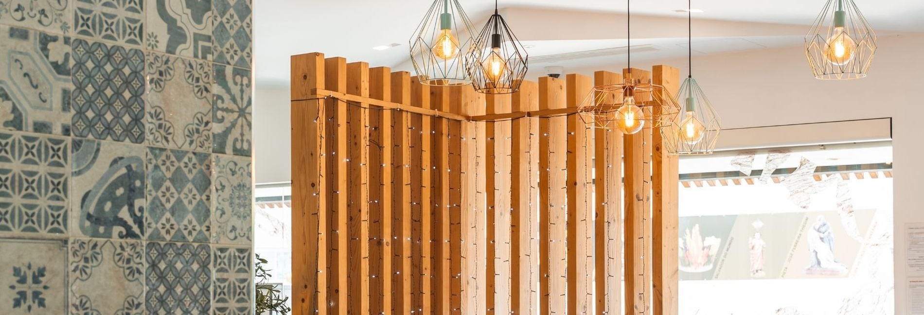 a wooden wall with lights hanging from the ceiling