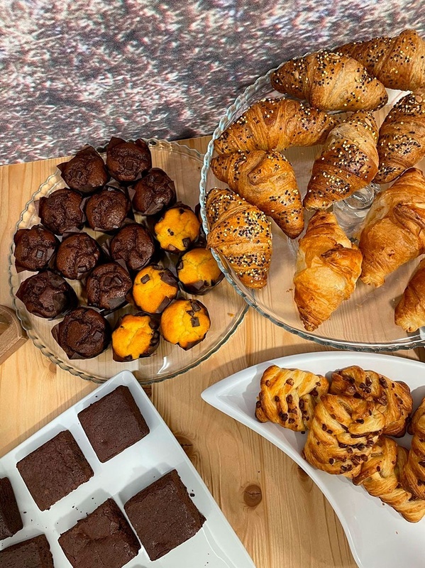 a variety of pastries and brownies are on a table
