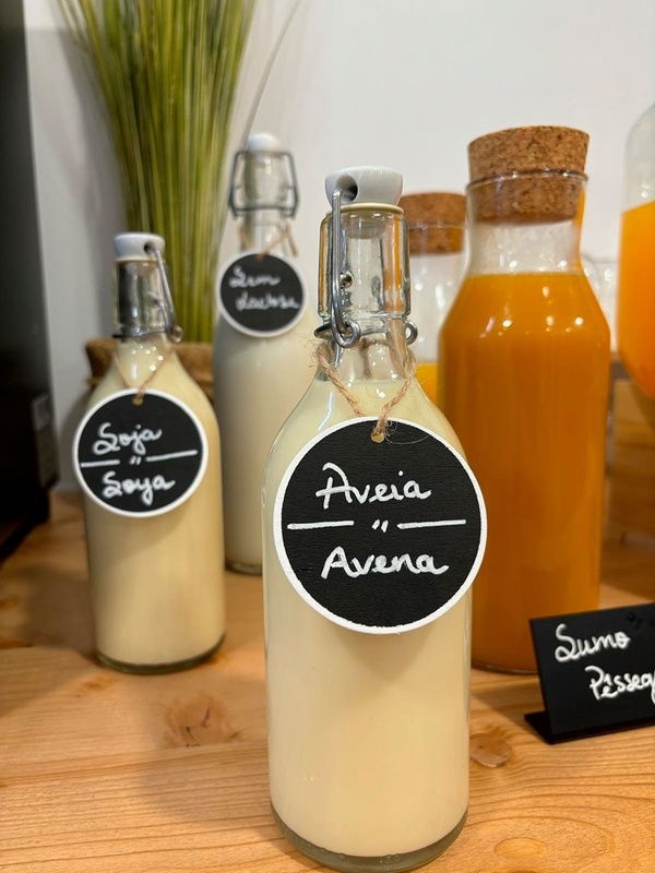 a bottle of aveia avena sits on a wooden table