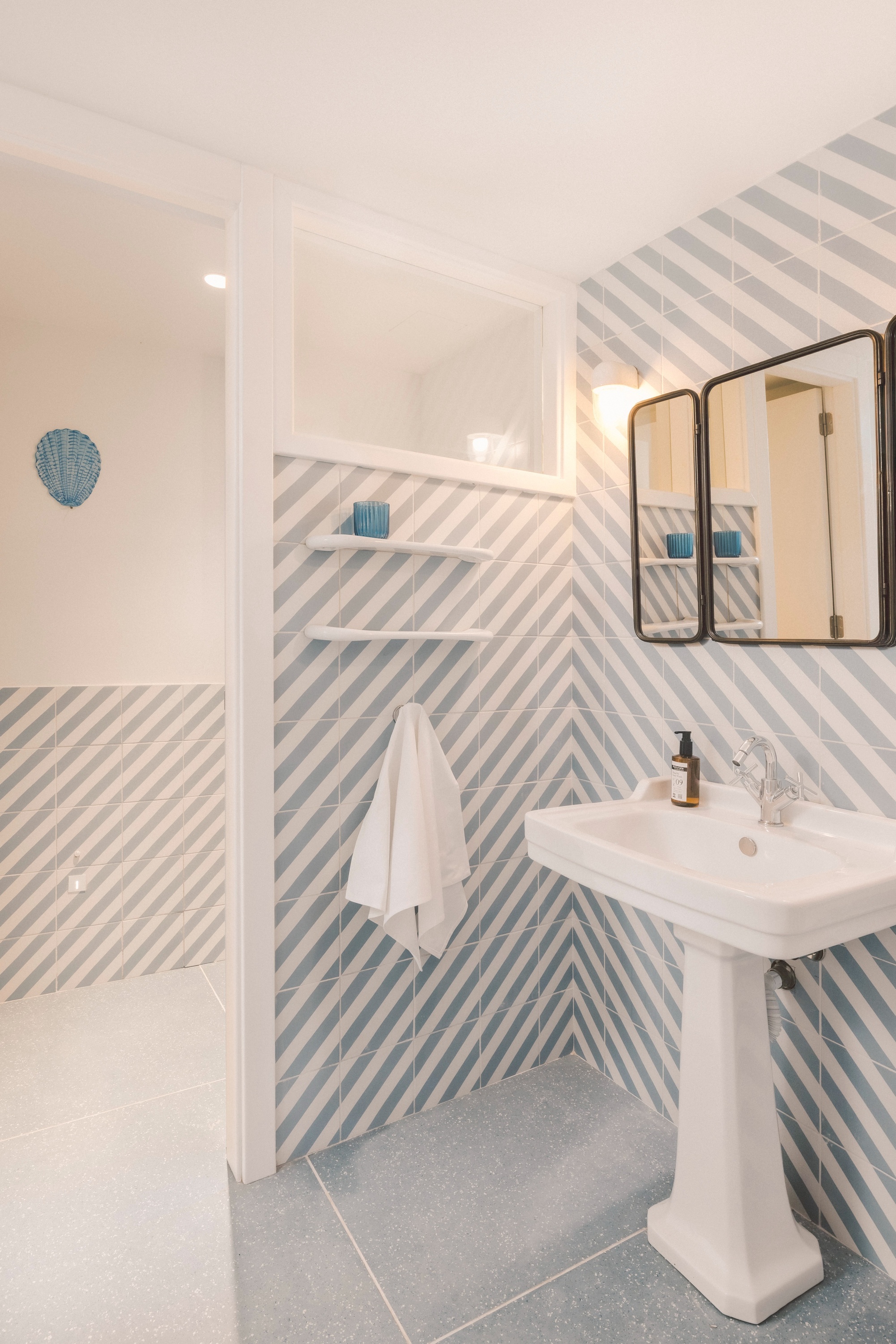 a hotel room with two beds and a painting on the wall