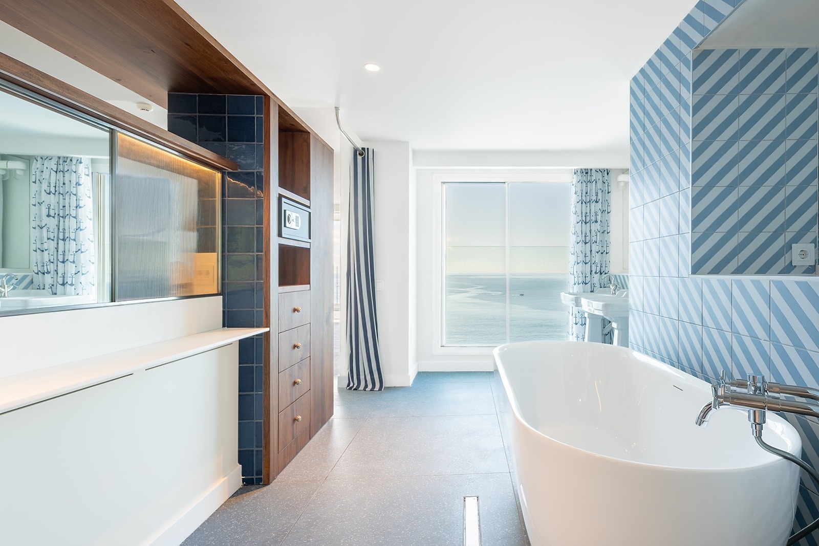 Luxurious Satocan: The Salmar bathroom with ocean view, free-standing tub, and nautical decor.