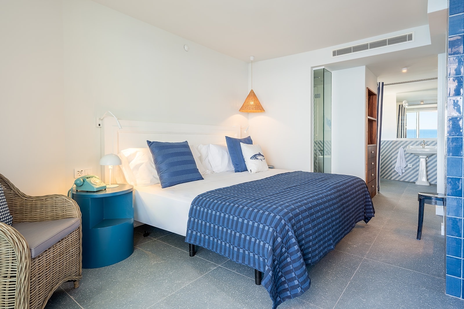 Satocan: The Salmar hotel room with blue accents, comfortable bed, and sea view.