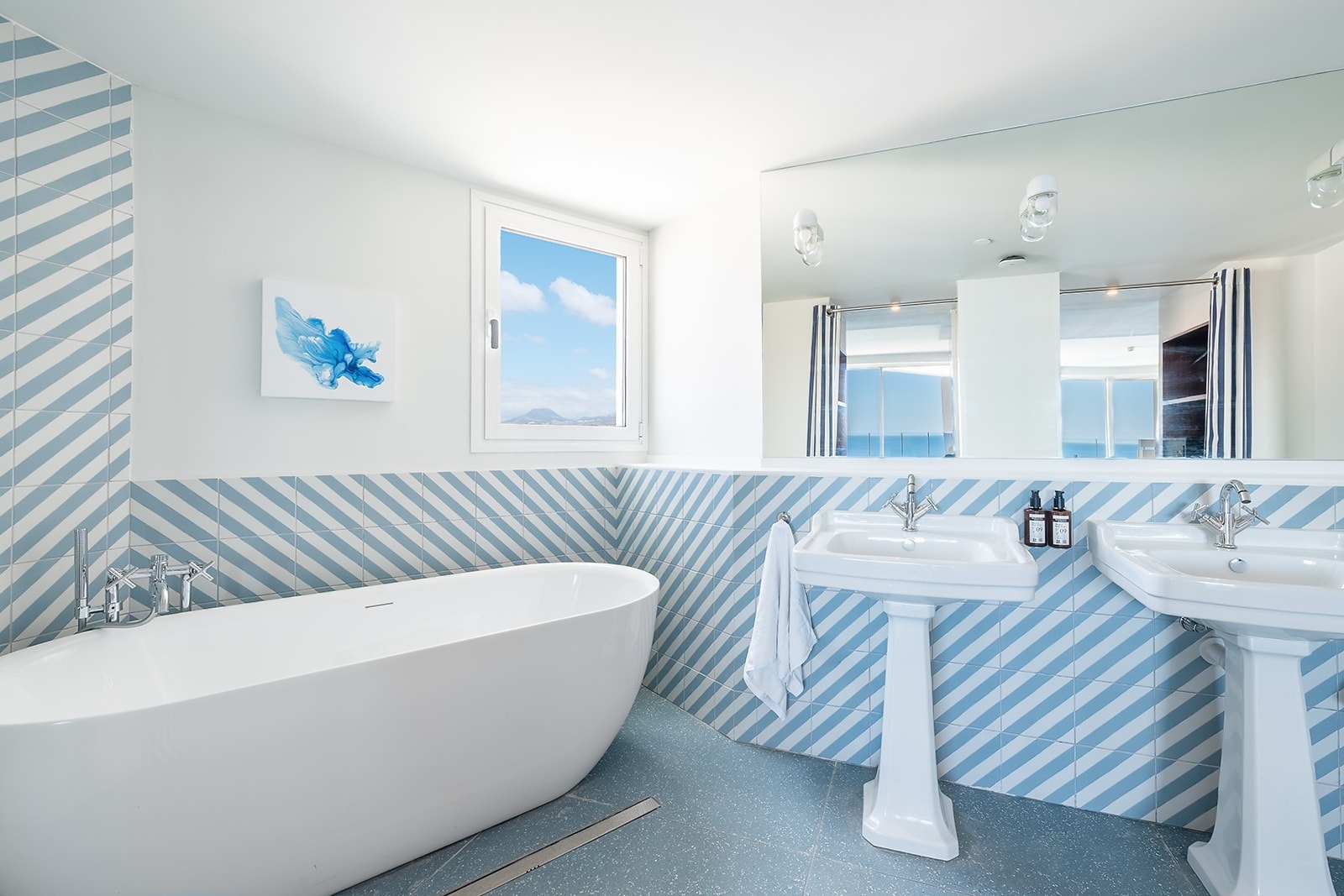 Satocan: The Salmar bathroom with a soaking tub, double vanity, and ocean view.