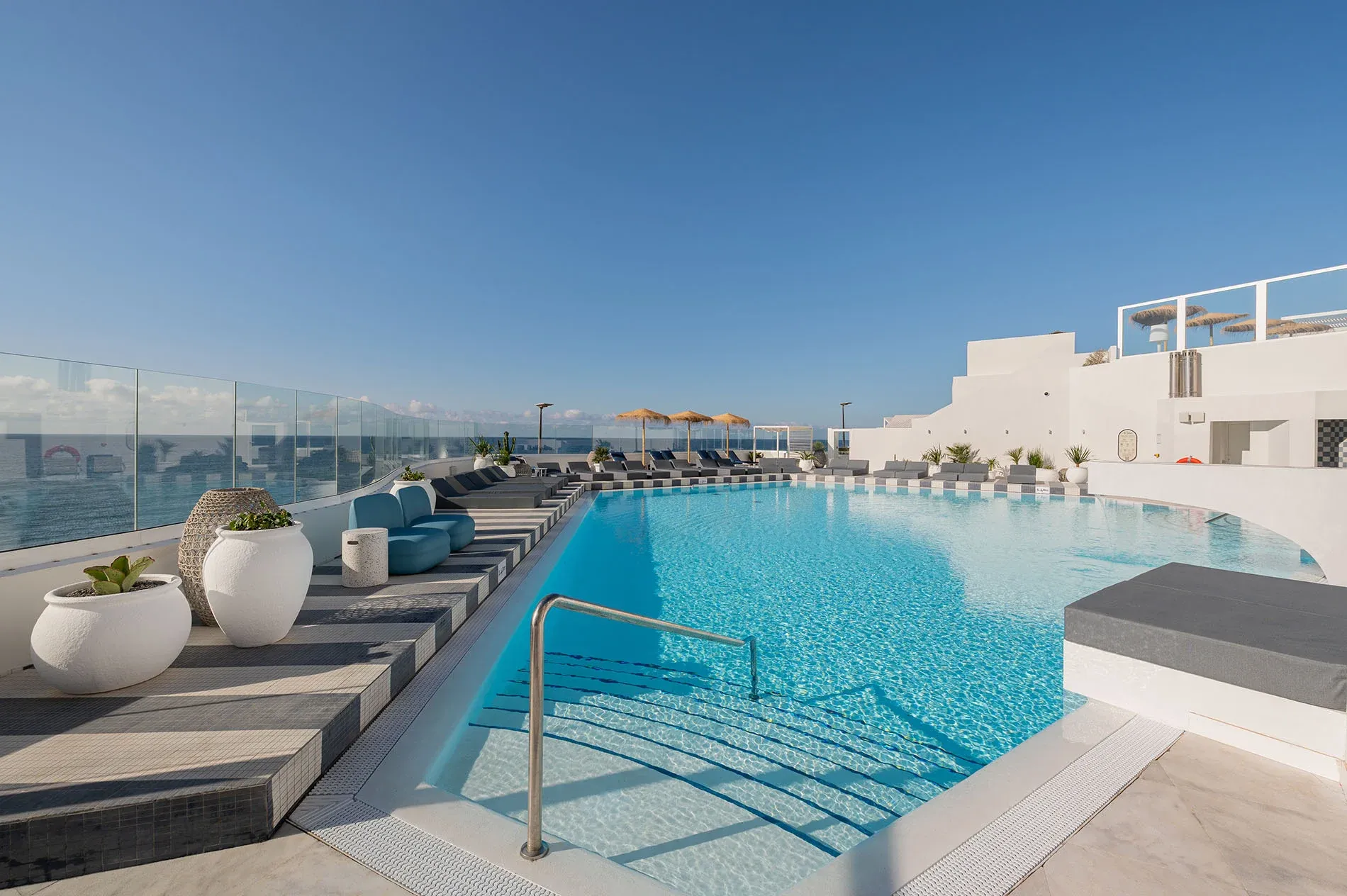 Oceanfront relaxation at Satocan: The Salmar. Infinity pool with sailboat view.