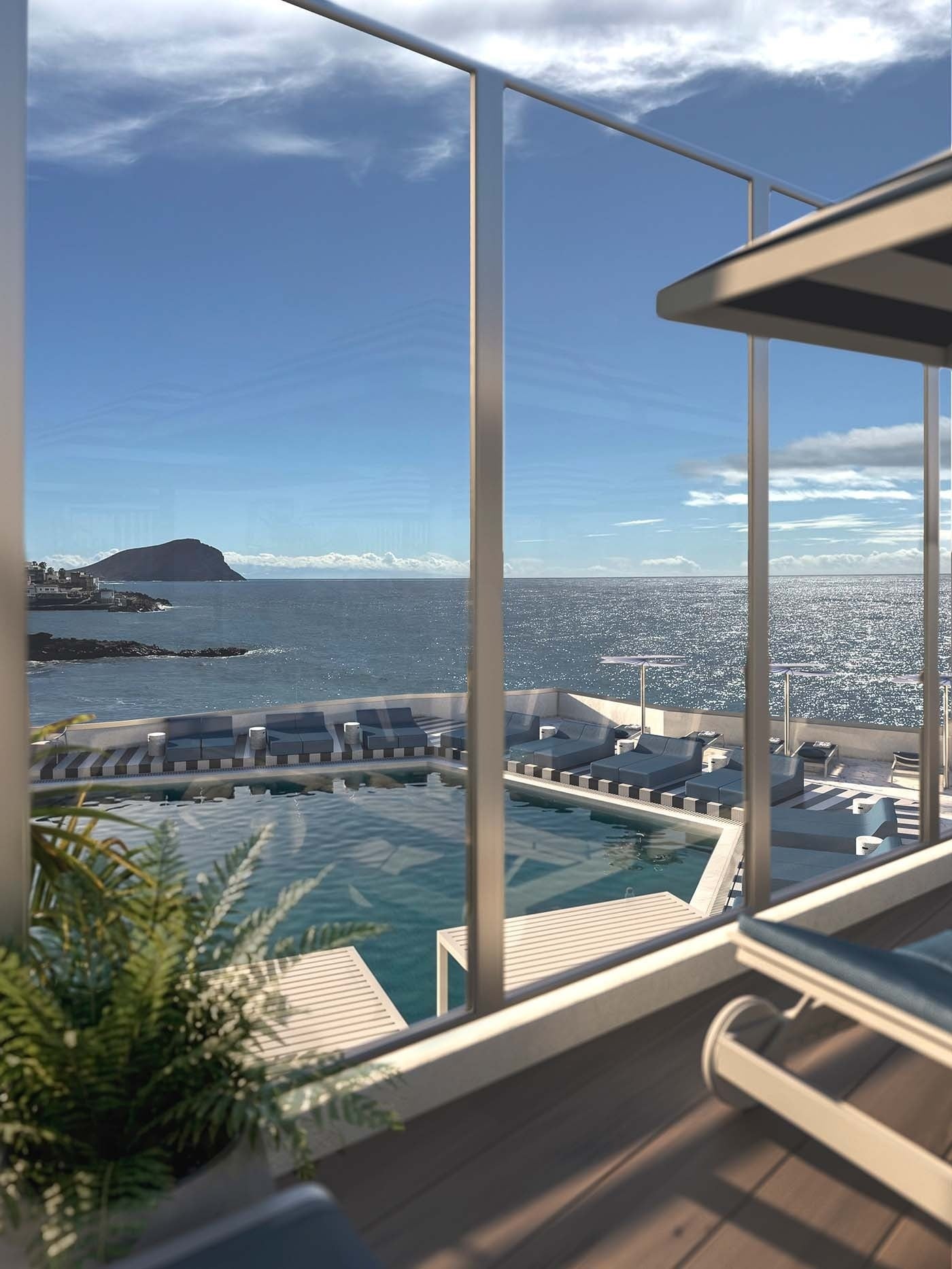 Vistas panorámicas al océano Atlántico y la costa de Tenerife desde la terraza de cristal de The Salmar, con la piscina y el área de hamacas en primer plano.