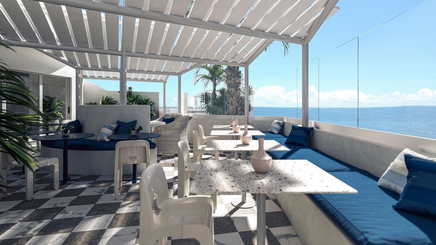 Terraza exterior del hotel The Salmar en Tenerife con suelos de damero, mobiliario de diseño blanco y vistas panorámicas al océano Atlántico bajo una pérgola moderna.