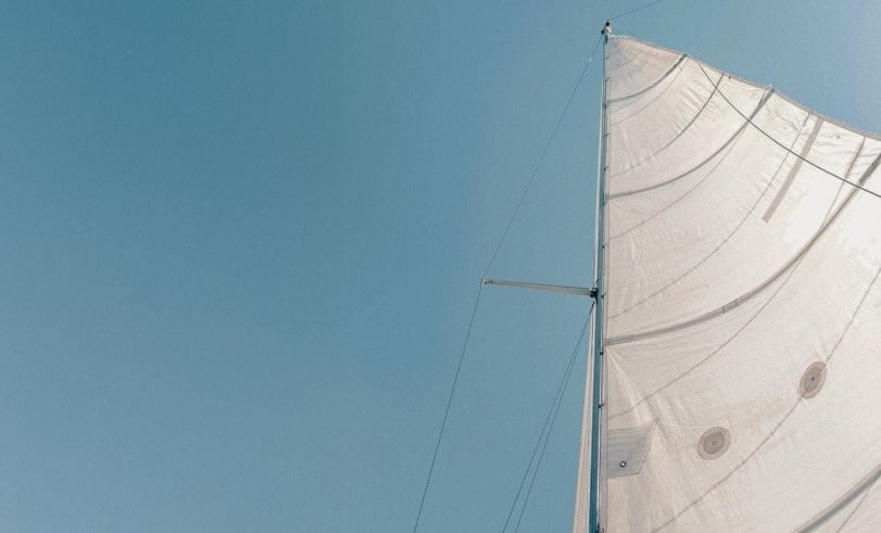 a large swimming pool surrounded by tables and umbrellas