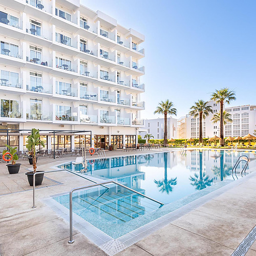 Piscina y edificio del hotel Dorobe: Hotel San Fermin con palmeras y tumbonas.