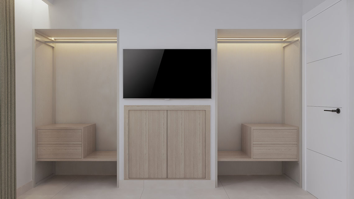 Modern hotel bedroom with geometric headboard, mounted TV, and open bathroom entrance. Sands Beach