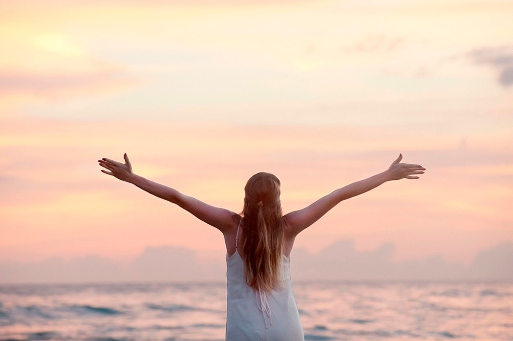 un niño y una niña están sentados en una manta comiendo helados .