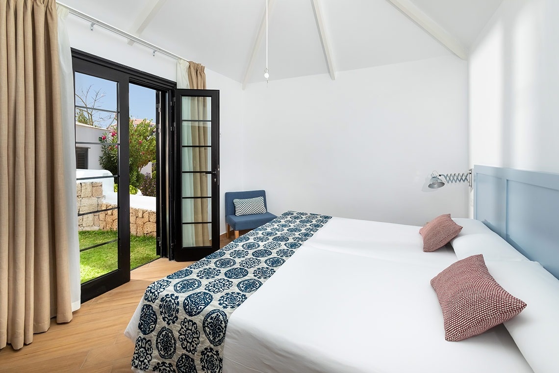 a bedroom with a king size bed and a chair