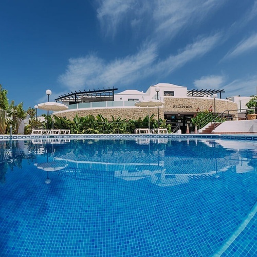 a swimming pool in front of a building that says reception