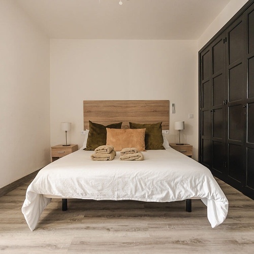 a small bedroom with a bed and two nightstands