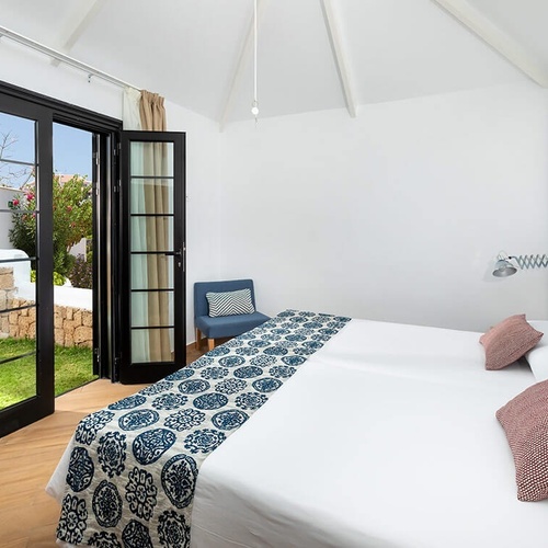 a bedroom with a king size bed and a chair