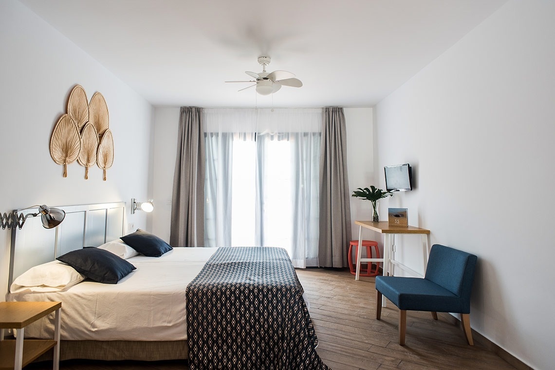 a hotel room with two beds and a tv on the wall