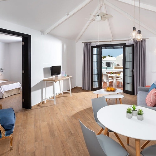 a living room with a couch a table and chairs