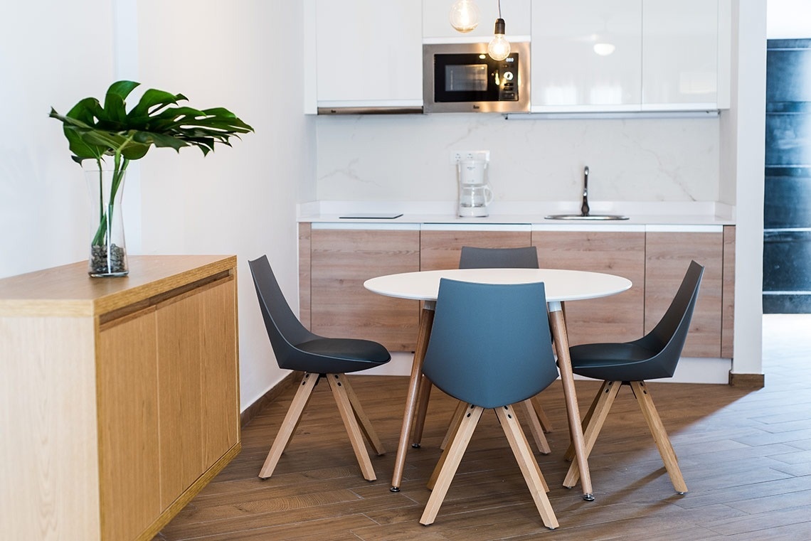 a kitchen with a table and chairs and a microwave