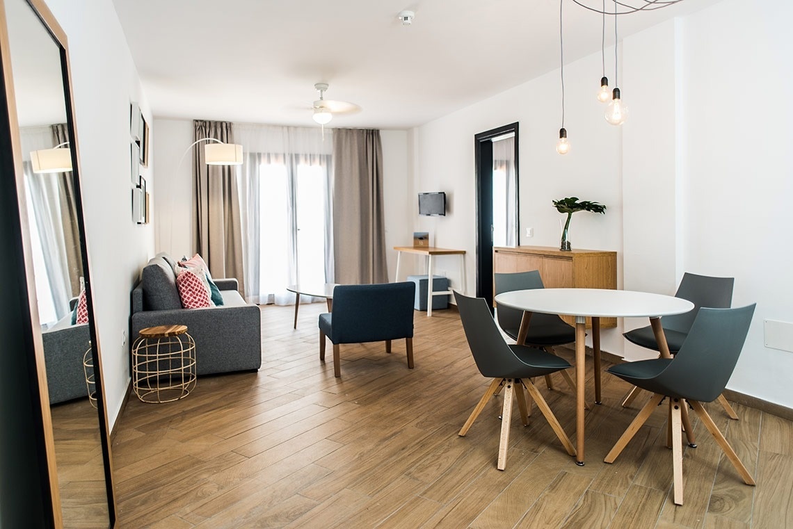 a living room with a couch a table and chairs