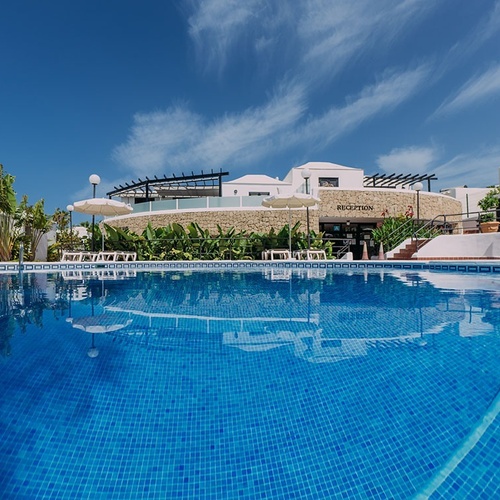 a large swimming pool in front of a building that says reception