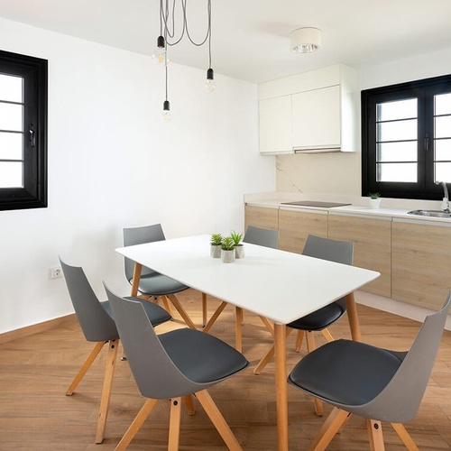 a kitchen with a table and chairs and a sink