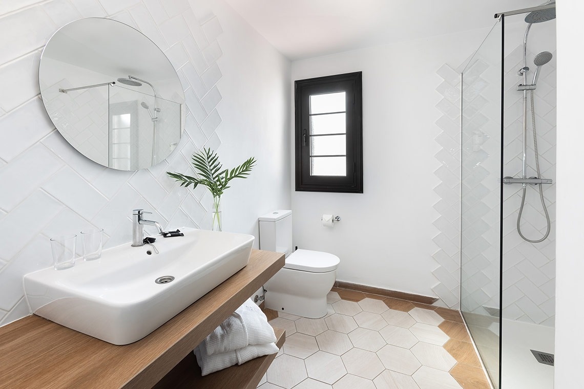 a bathroom with a toilet a sink and a shower