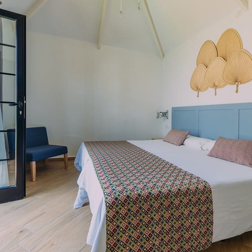 a bedroom with a king size bed and a chair