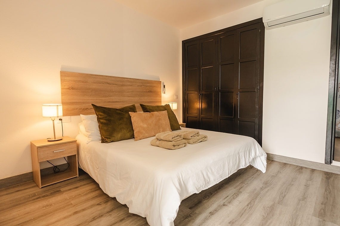 a bedroom with a king size bed and a nightstand