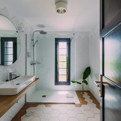 a bathroom with hexagonal tiles and a sink